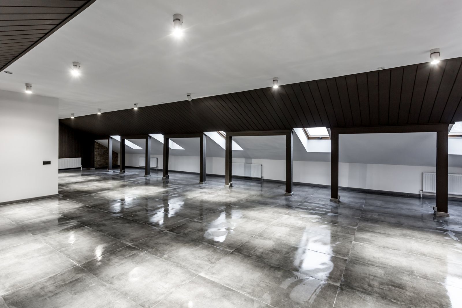 Gray high-gloss epoxy floor in a finished loft space